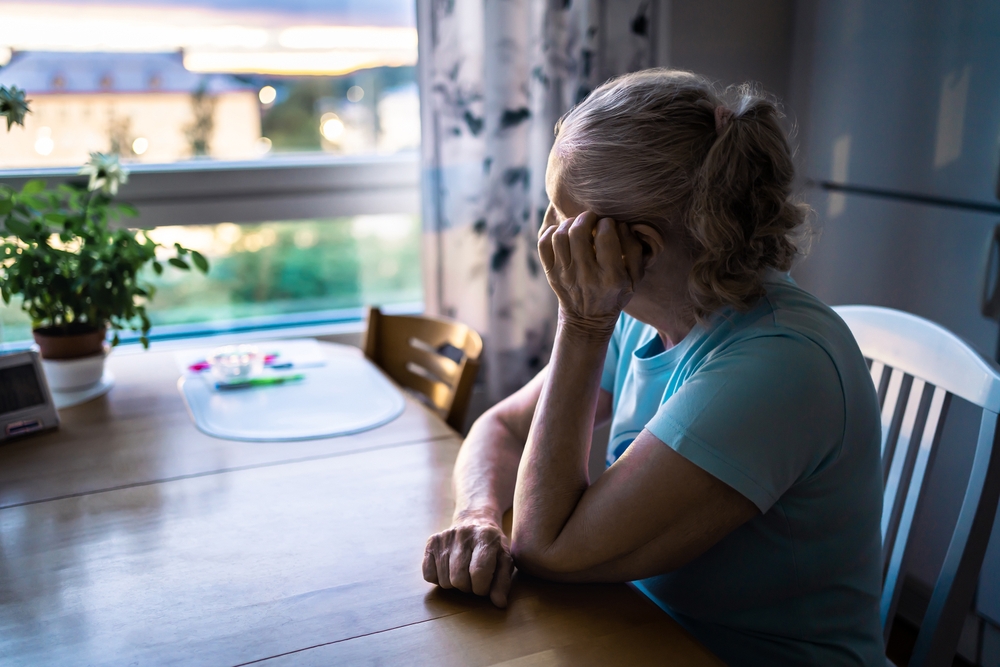 A senior woman is lonely at home.