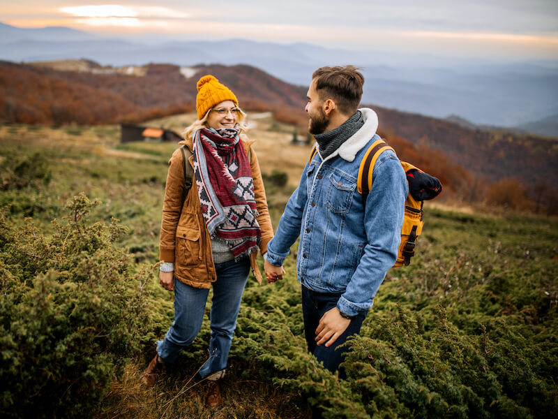 Hikers climbing on the mountain, man wearing hearing aids. 