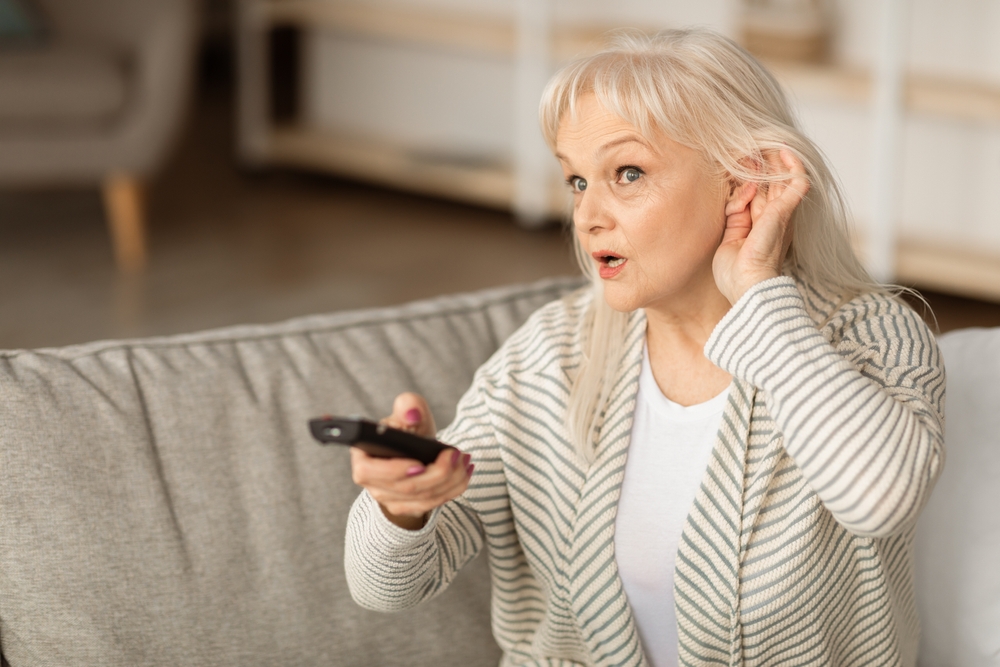 Lady having trouble hearing due to hearing loss