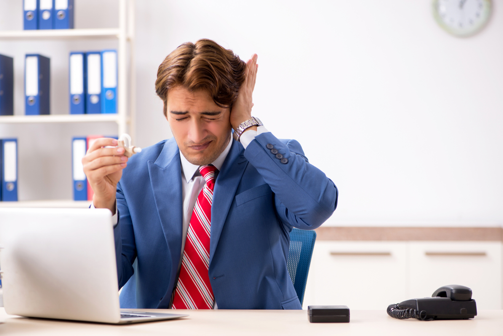 Person struggling to hear at work