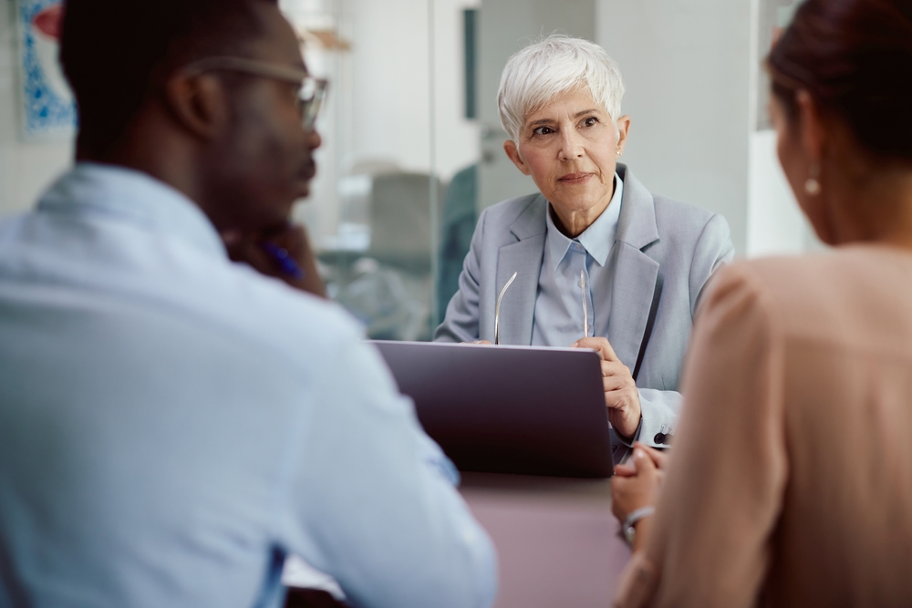 female professional struggling with conversation in the office.